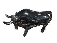 Side profile showing detailed carving and white veining on the polished black marble bull sculpture.