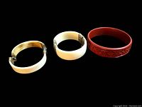 Three vintage Chinese bangles on black background showing overall appearance