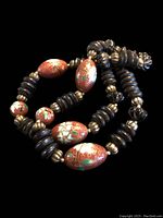 Close-up of the cloisonné and dark disc beads showing design and bead texture.