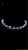 Photo of Italian Murano glass beaded necklace showing blue beads with floral designs and the clasp.