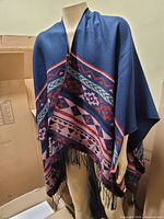 Blanket scarf draped on a mannequin showing pattern and size.