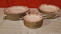 Three stacks of plates including dinner, luncheon and side plates