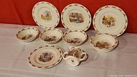 Full lot showing 7 plates/bowls and 1 creamer jug with Bunnykins illustrations and bunny border pattern.