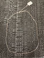 Full view of the 18-inch sterling silver necklace laid flat on textured black fabric, showing full length and clasp.