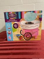 Boxed cotton candy maker with colorful carnival cart design and cotton candy images