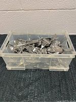 Plastic tub filled with assorted metal forks, spoons, and knives arranged mixed inside.