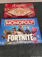Top view of the boxed Scrabble game and Fortnite Monopoly game showing the fronts of the boxes