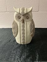 Front view of the fabric owl statue showing button eyes and embroidered details