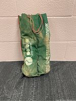 Green fabric carrying bag with 'Boccioletta' logo, containing bocce balls.