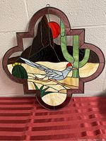 Front view of the 21x21 stained glass panel showing the desert scene with mountain, red sun, cactus, and bird.