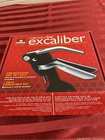 Closed red box showing Monsieur Bar Excaliber branding and product image