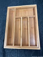 Top-down view of the wooden drawer organizer showing the compartment layout and overall shape.