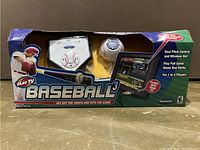 Front view of the Radica PlayTV Baseball 3 console in original box showing wireless bat, pitching device, game unit, and artwork.
