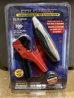 Front view image showing Cold Heat cordless soldering tool and wire stripper in original sealed plastic packaging with product features and branding visible.