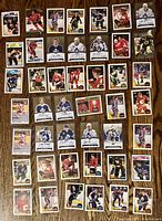 Full layout of approximately 42 hockey cards featuring numerous players and signed cards.