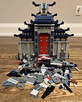 Front view of LEGO Ninjago Movie 70617 Temple of The Ultimate Weapon assembled with extra loose parts scattered in front