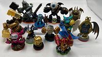 Multiple Skylanders characters figurines arranged in rows showing colors and details