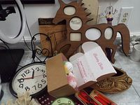 Clock, wooden dog and sun photo frames, decorative planter, jewelry stand, decorated chopsticks, porcelain items, coral sculpture, and boxed doll