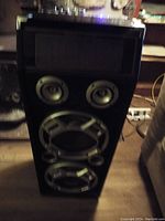 Front view of the Pyle Bluetooth speaker featuring two mid-size speakers and two larger subwoofers in a black cabinet.