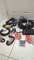 Snake cables and various audio cables coiled on floor with packaged Hosa adapters visible.