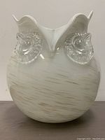 Front view of a large owl-shaped vase made from Italian glass, predominantly white with gold streaks and clear glass eyes, showcasing its unique design and condition.