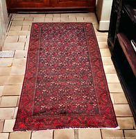 Full view of rug laid on tiled floor showing overall pattern and color