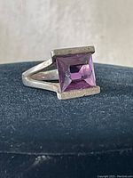 Close-up side angle image of the sterling silver amethyst ring showing the band and gemstone setting.