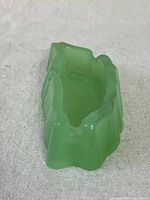 Top view showing the irregular shape and glossy green jadeite glass surface.