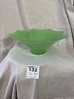 Side view of the vintage jadeite glass fruit bowl showing its scalloped edges and shape.