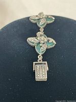 Front view showing three connected floral links and box clasp