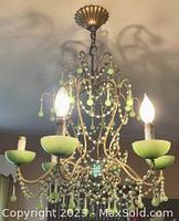 Full view of hanging chandelier with illuminated bulbs showing overall design and dimensions