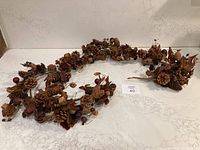 Full view of dried foliage garland laid flat showing length and density