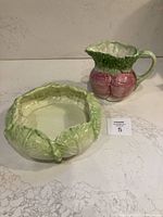 Both ceramic bowl and pitcher shown on countertop, highlighting their vegetable-inspired design and size relative to each other.