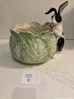 Front view of Fitz & Floyd ceramic planter showing the cabbage leaf texture and bunny figurine attached on the side.