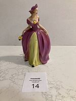 Front view of the Goebel figurine showing dress, flowers held in hand, and facial features.