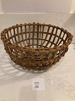 Image of large round rustic woven basket showing the overall shape and open lattice weave.