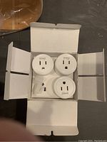 Three Gosund smart plugs displayed in their original open white box, showing the front side of each plug with outlets and indicator lights visible.