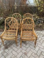 Four bamboo and rattan chairs arranged on outdoor patio, showing overall set