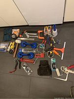 Full spread of assorted hand tools and carpet stretcher suction handles