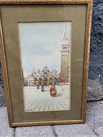 Full view of framed watercolour painting showing the architecture and street scene of Piazza San Marco in Venice, with soft natural lighting.