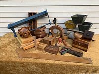 Photo showing a variety of retro and antique wooden items including salad bowls, sushi blocks, unique carved decorative wooden pieces, boxes, and utensils arranged together.