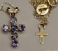 Both cross pendants and chain stamps visible