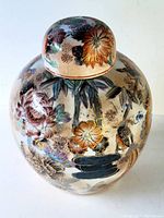 Top and side view showing hand painted flowers and birds with gold accents on ginger pot and matching lid.