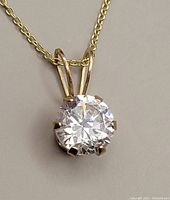 Close-up of solitaire round cubic zirconia pendant in six-prong 10kt gold setting