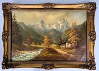 Frontal photo of the oil on canvas painting showing the mountainous landscape, cabin, stream, and autumn trees, framed in ornate carved wooden frame with gold finish.