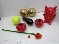 Photo showing all items on a white surface with clear detail of colors, sizes and shapes