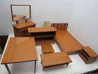 Photo showing 10 pieces: dresser with mirror, kitchen table, bed, bookcase, coffee table, larger and smaller end tables, floor lamp, and stools/chairs.