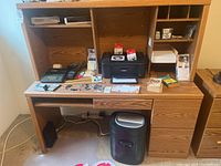 Full view of wooden desk with Canon printer on top and Royal shredder below, plus organized office supplies, calculators, alarm clocks, and scanner