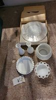 Full view of all five hobnail milk glass pieces on carpet with original cardboard box containing large plate