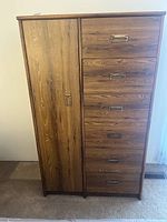 Front view of the vintage retro tall dresser showing six drawers with brass handles on the right and a tall cabinet door on the left.